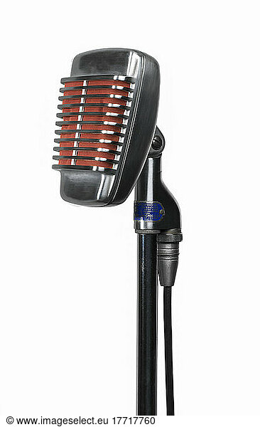Close-up of a vintage  chrome studio microphone on a stand against a white background; Studio Shot