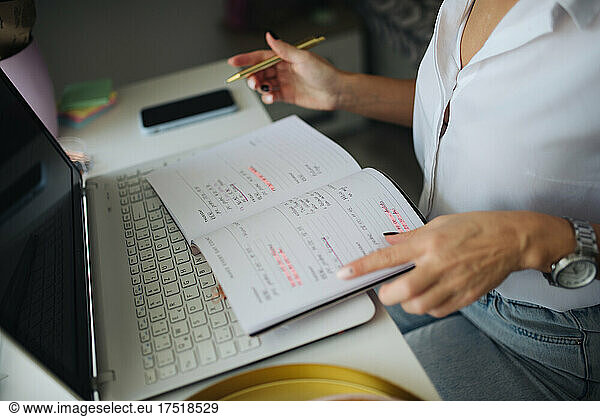 Close-up of a woman chekcing her to do list.