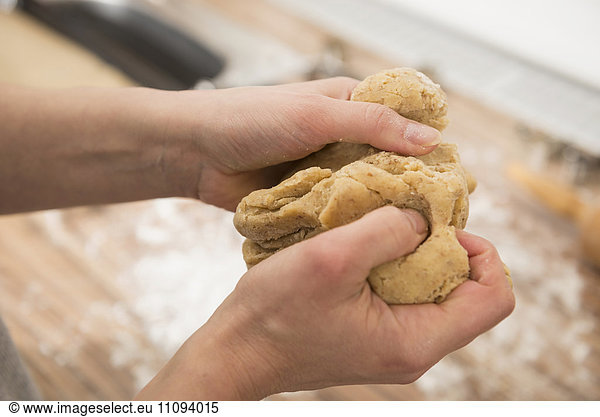 Close-up of a woman kneading dough
