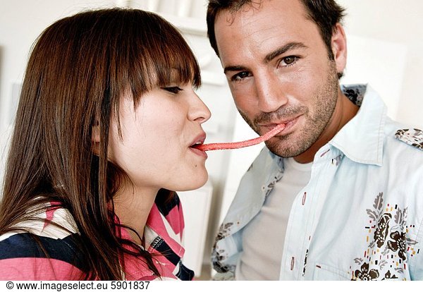 Close_up of a young couple eating candy