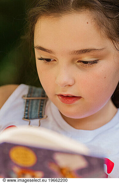 Close up of a young girl reading a book