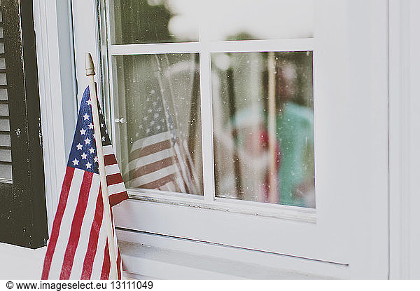 Close-up of American flag at window