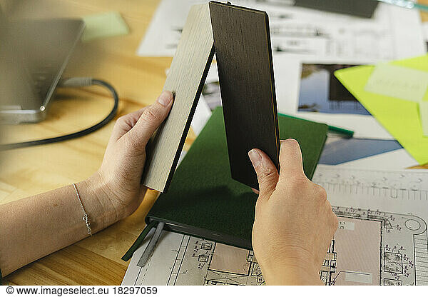 Close-up of architect holding samples in office