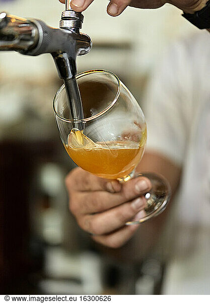 Close-up of barkeeper tapping beer