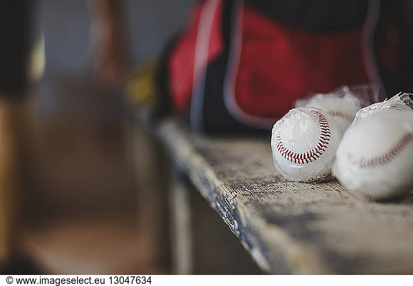 Close-up of baseball balls on table in sports dugout
