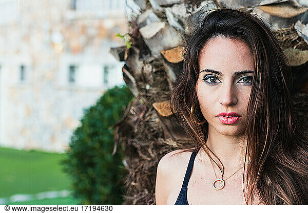 Close-up Of Beautiful Girl On A Palm Tree