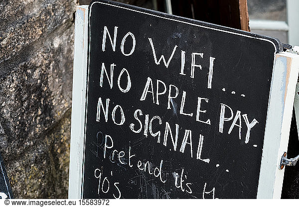 Close up of blackboard outside store  announcing unavailability of WiFi.