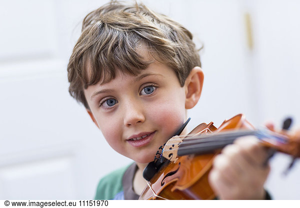 Close up of boy holding violin
