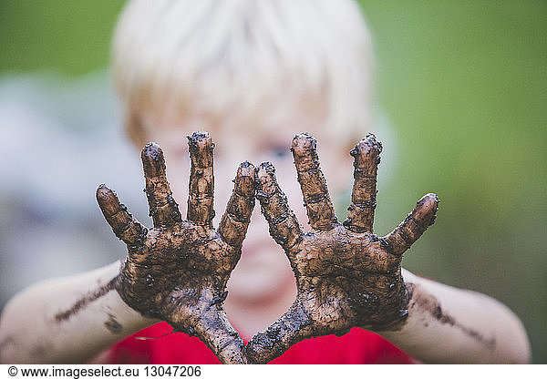 Close-up of boy showing dirty hands