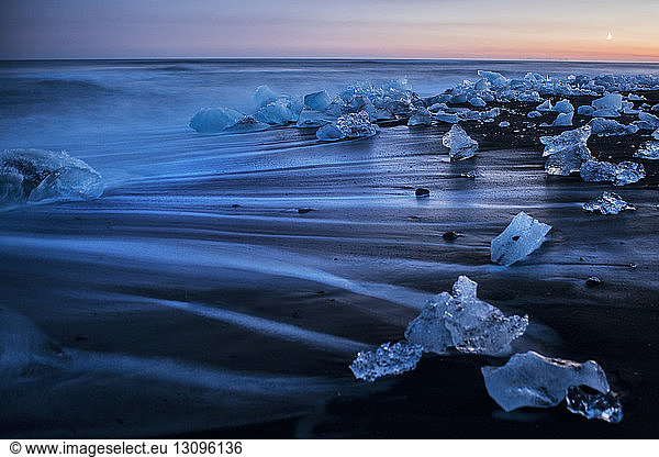 Close-up of broken icebergs on shore at beach