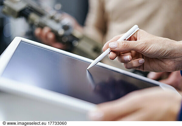 Close-up of businesswoman using digitized pen on tablet
