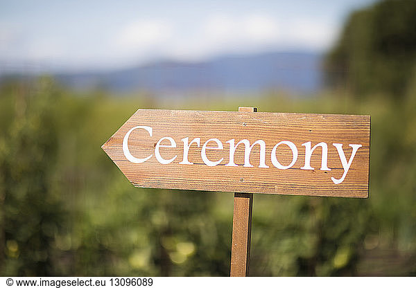 Close-up of ceremony text on sign board at field