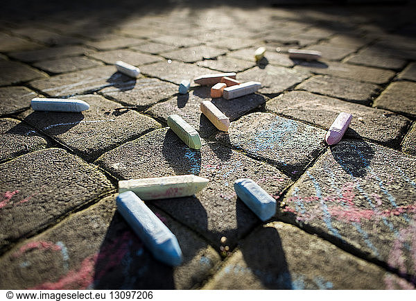 Close-up of chalks on footpath