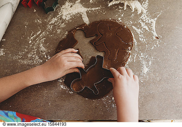 Close up of Child's Hands Making Gingerbread Men Cookies