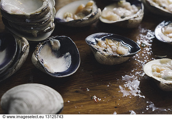 Close-up of clams on wet wooden table