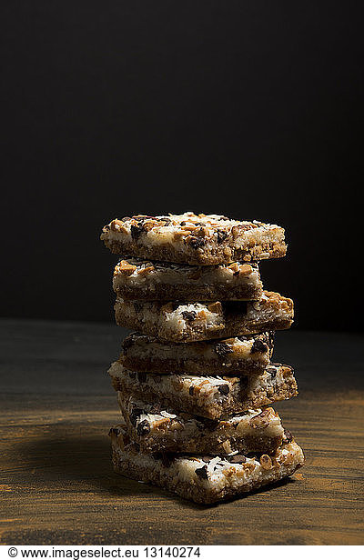 Close-up of coconut five layer bars on wooden table