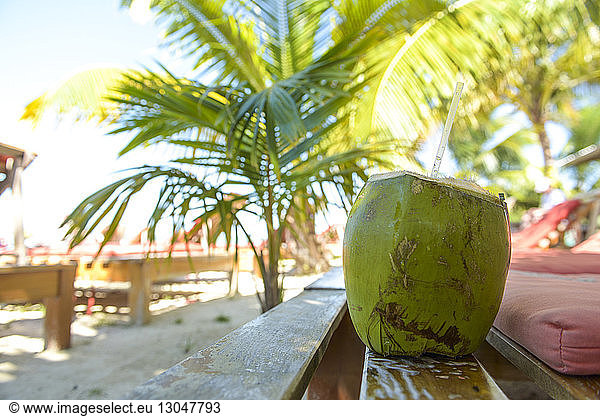 Close-up of coconut water on wooden table