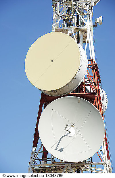 Close-up of communication tower against clear blue sky