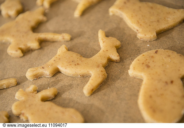 Close-up of cut out dough reindeer shaped cookies during preparing cookies