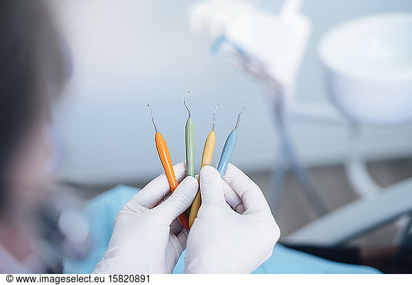 Close-up of dentist holding dental instruments