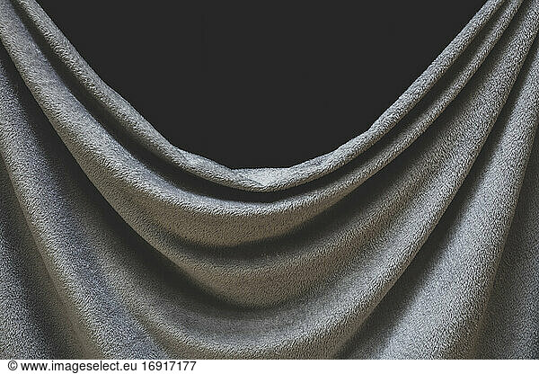 Close up of draped grey velvet fabric  focus on folds and creases