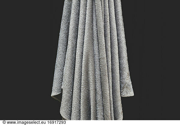 Close up of draped grey velvet fabric  focus on folds and creases