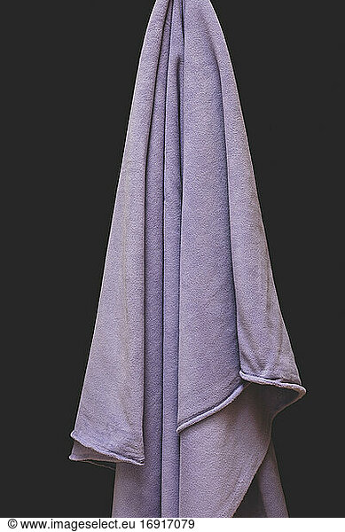 Close up of draped purple fleece fabric  focus on folds and creases
