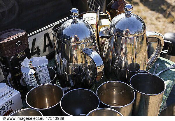 Close up of drinks flasks and cups  a drinks break on safari