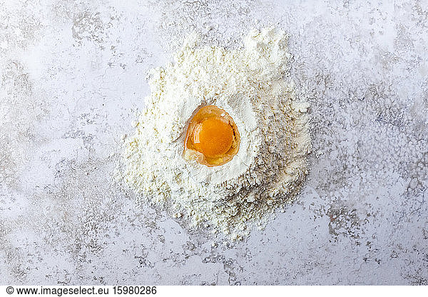 Close-up of egg yolk in flour