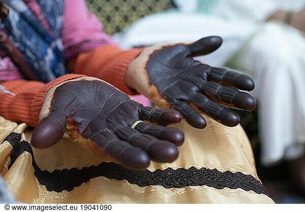 Close up of elderly woman painted hands with henna in celebration.