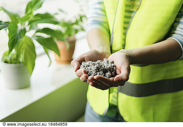 Close-up of engineer holding sand in cupped hands