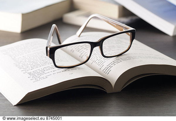 Close-up of Eyeglasses on Open Book  Studio Shot