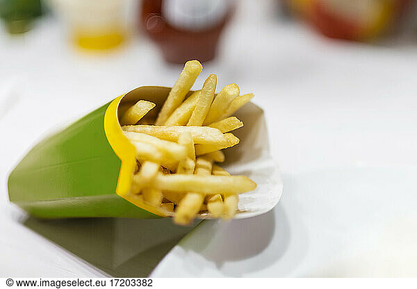 Close up of fast food french fries on table