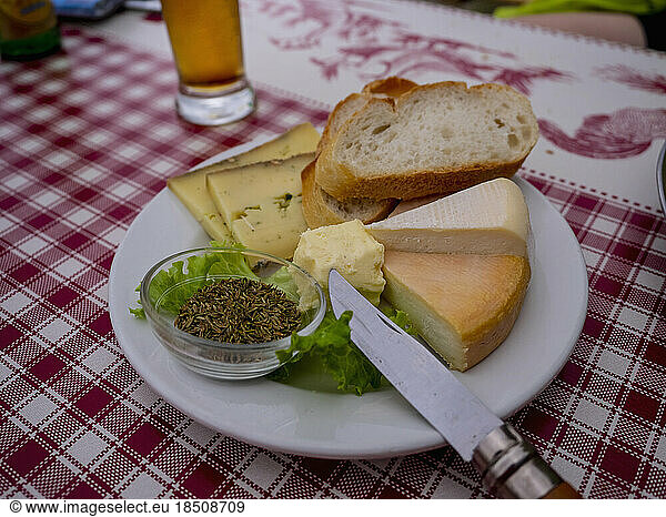 Close-up of French cheese and baguette meal on table  Vosges  France