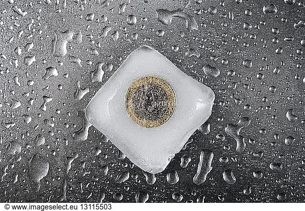 Close-up of frozen European Union coin on table