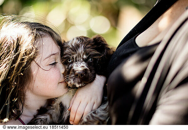 Close Up of Girl Hugging Cocker Spaniel Puppy in San Diego
