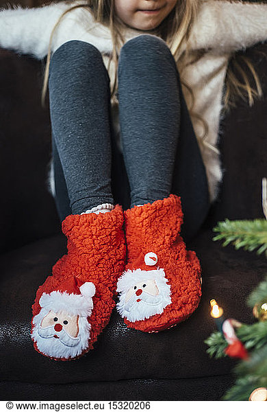 Close-up of girl wearing cozy Santa Claus footwear