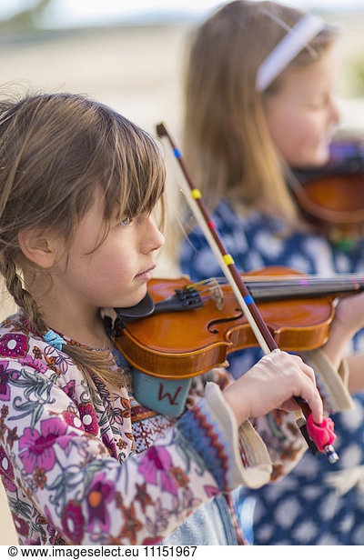 Close up of girls playing violin