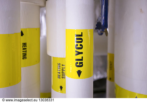 Close-up of glycol text label on pipe in factory