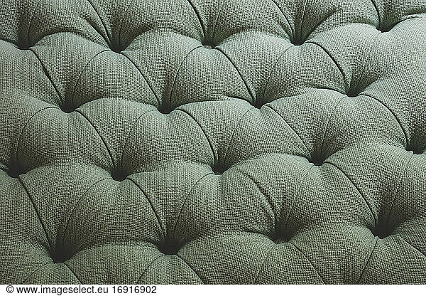 Close up of green linen couch and cushioning