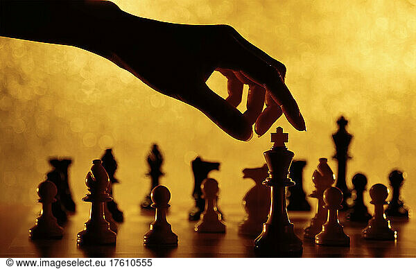 Close-Up of Hand and Chess Pieces