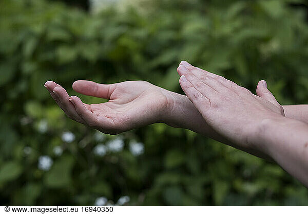 Close up of hands touching  EFT tapping therapy technique.