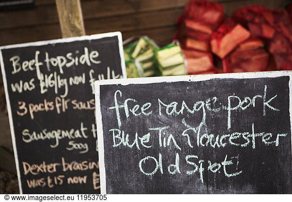 Close up of handwritten blackboard at farm shop advertising free range pork and beef.