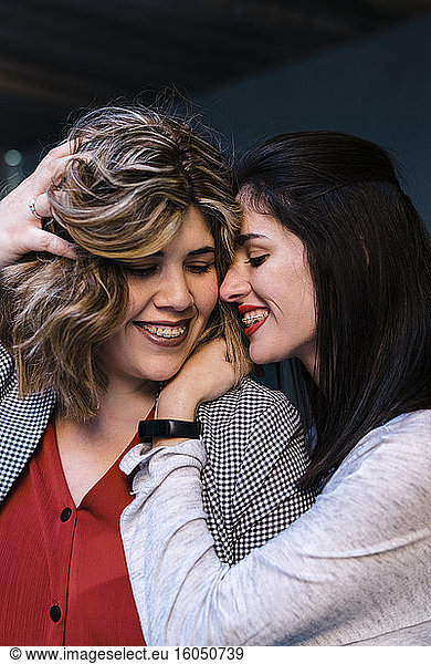 Close-up of happy lesbian couple romancing in city