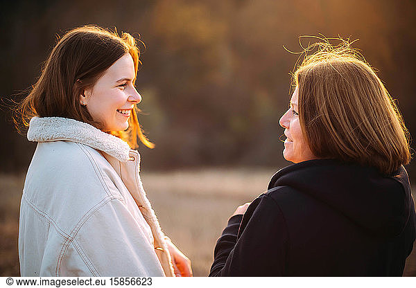 Close-up of happy mother and daughter during sunset.