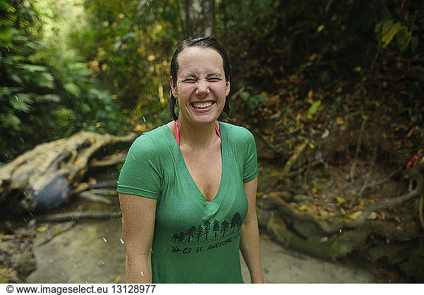 Close-up of happy woman standing in river