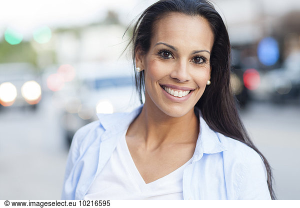 Close up of Hispanic woman smiling outdoors
