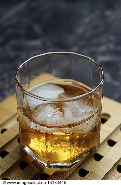 Close-up of ice cubes in alcoholic drink on tray