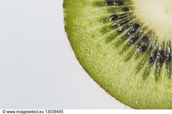 Close-up of kiwi slice on white background