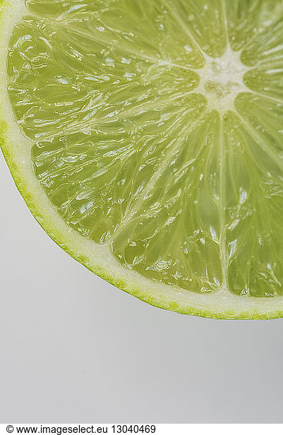 Close-up of lime slice on white background